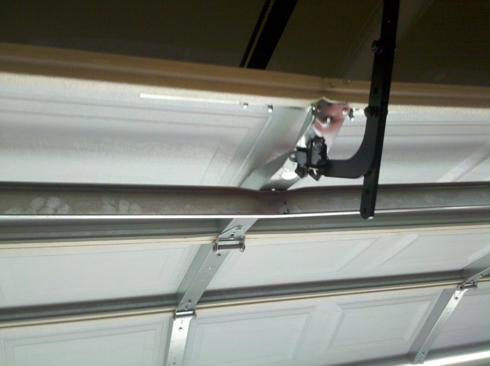 Damaged Garage Door Section No OP Bracket and Strut Installed Wrong